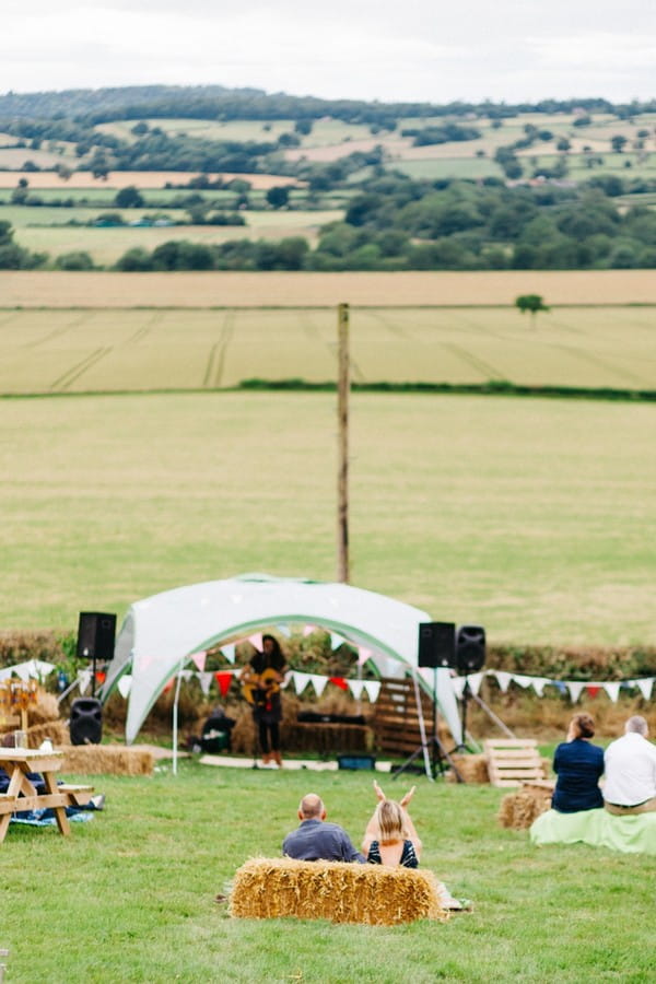 Musician performing in field at festival wedding