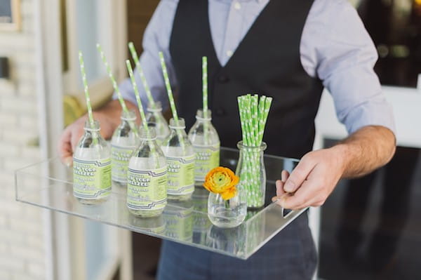 Tray of bottles with green straws