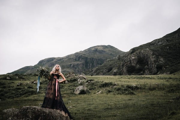 Bride wearing dark blue dress in countryside of Lake District