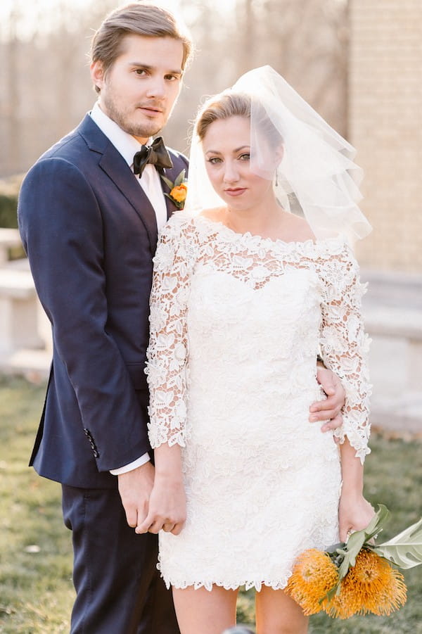 Groom with bride in short lace dress