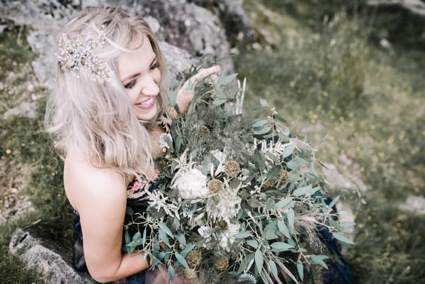 Bride holding rustic, natural wedding bouquet