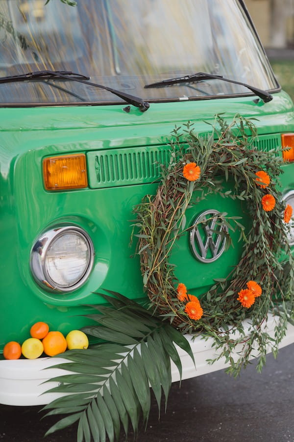 VW van with orange flower wreath and citrus fruits on the front