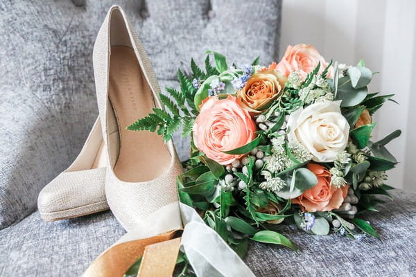 Bridal shoes and blush pink and white wedding bouquet