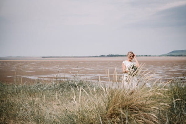 Bride by beach in Cumbria