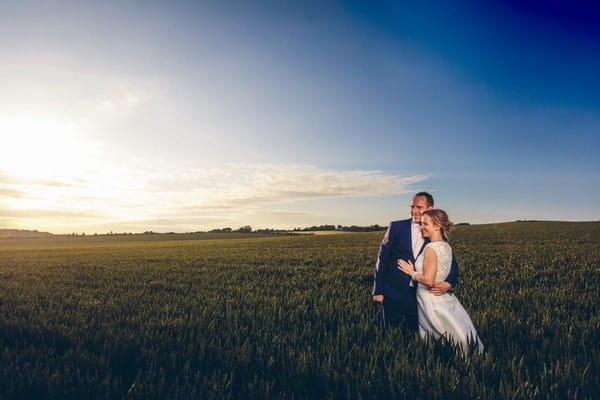 Bride and groom in field