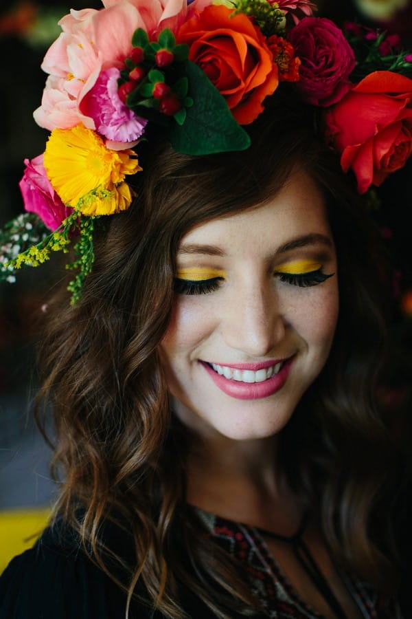 Woman with colourful flower crown and yellow eyeshadow