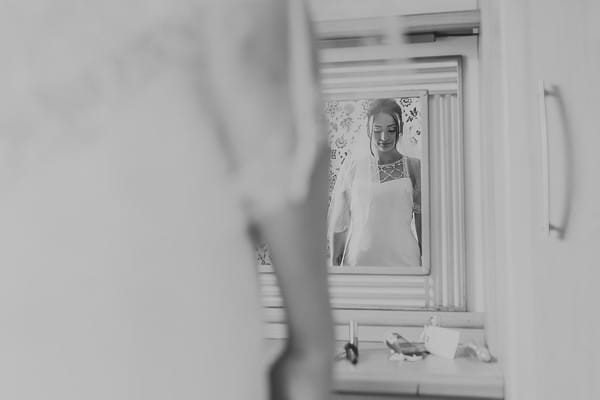 Bride looking in mirror