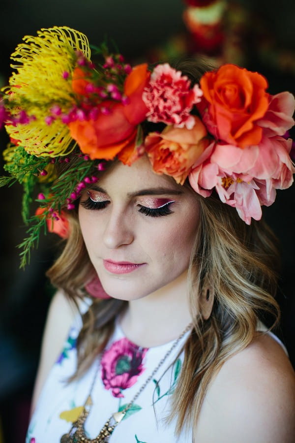 Woman with colourful floral crown and pink eyeshadow