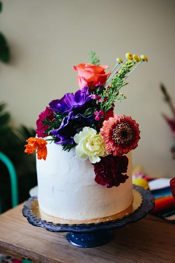 White cake topped with colourful flowers