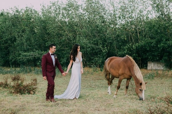 Bride and groom by horse