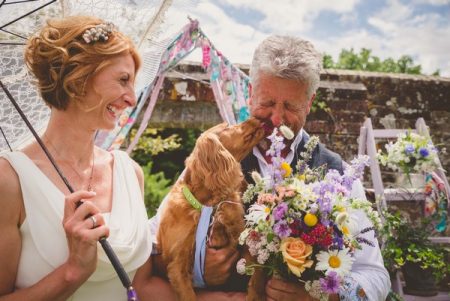 Bride laughing as dog licks groom's face - Picture by Photography by Paloma