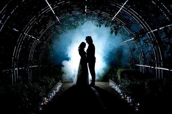 Silhouette of bride and groom in greenhouse surrounded by smoke - Picture by Matt Selby Photography