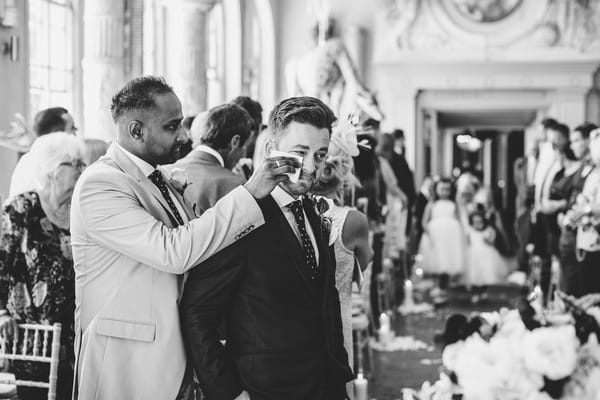 Best man wiping away groom's tears as bride walks down the aisle - Picture by Voyteck Photography