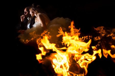 Bride and groom behind flames - Picture by Steven Herrschaft Photography