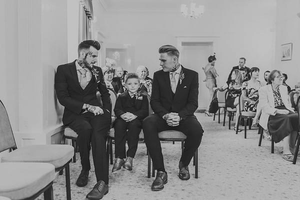 Groom, best man and pageboy waiting for bride