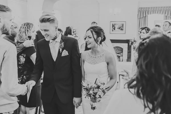 Bride and groom leave wedding ceremony