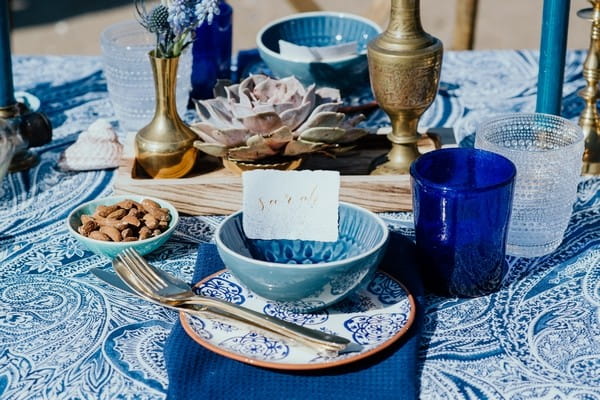 Wedding place setting with blue and gold styling