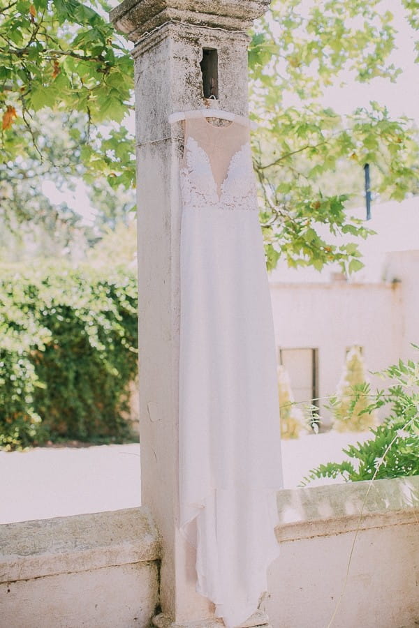 Wedding dress hanging from pillar