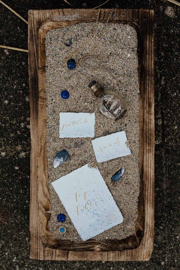 Wedding stationery with shells in sand