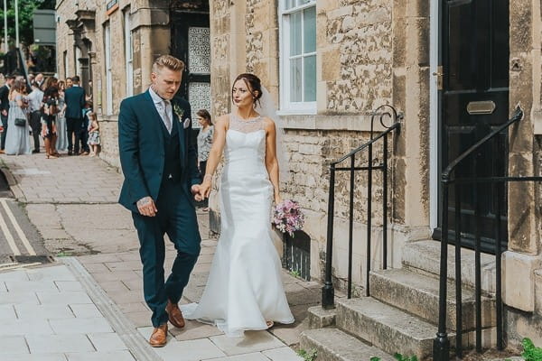 Bride and groom walking in town