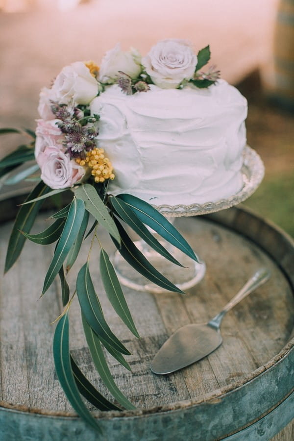 Simple wedding cake with flowers and foliage