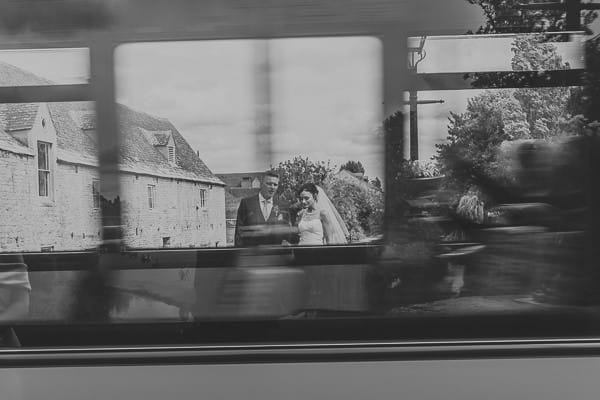 Bride and groom seen through window of passing bus