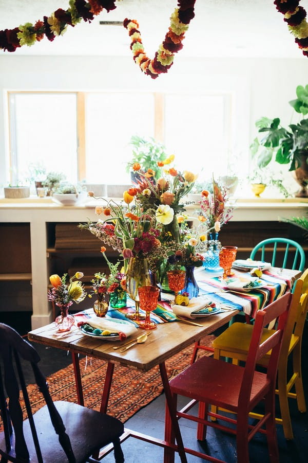 Table dressed with colourful flowers and tableware