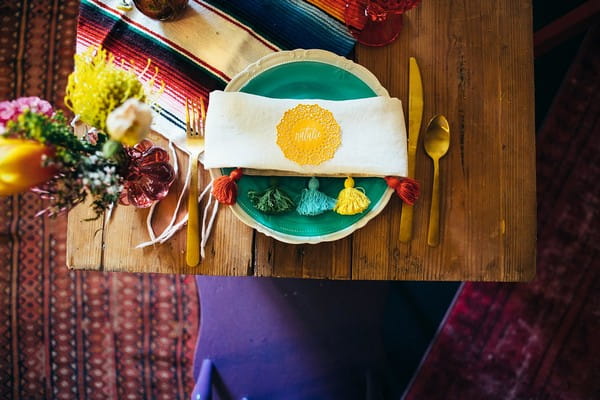 Colourful place setting with napkin with tassels