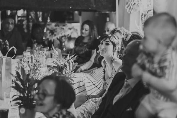 Wedding guests listening to groom speech