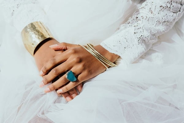 Bride's gold bracelets and blue ring