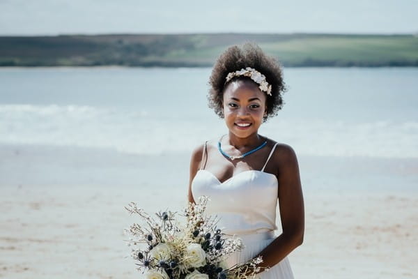 Smiling bride holding bouquet