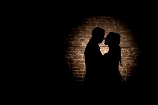 Shadow of bride and groom on wall