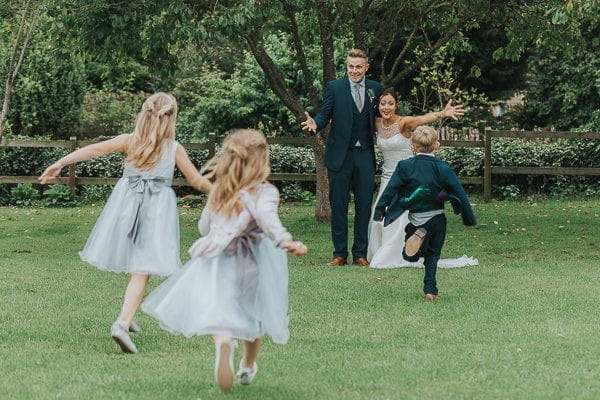 Children running towards bride and groom