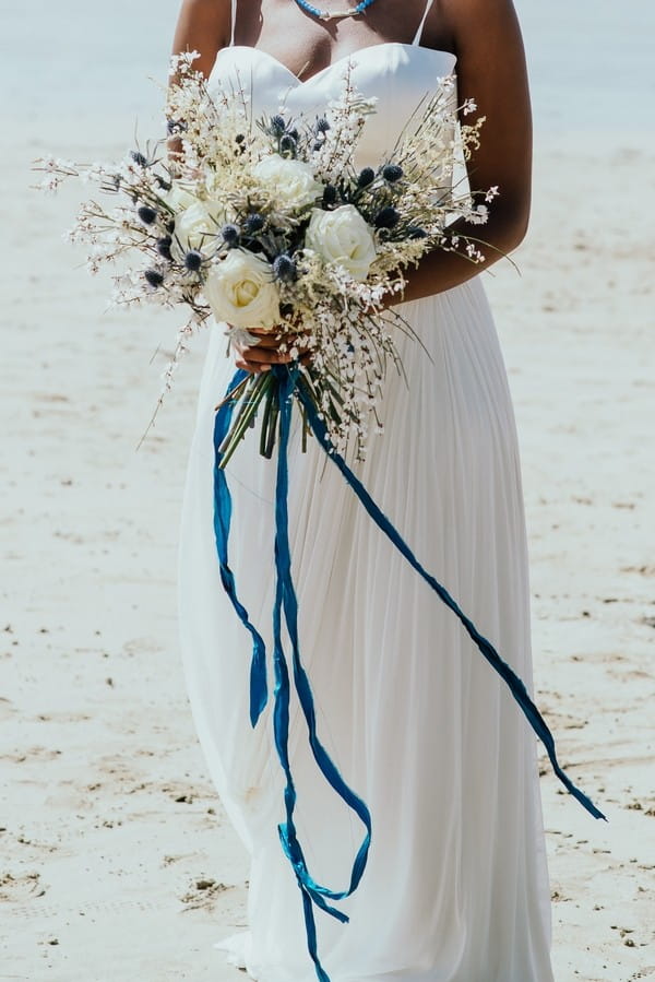 Rustic wedding bouquet with long blue ribbon