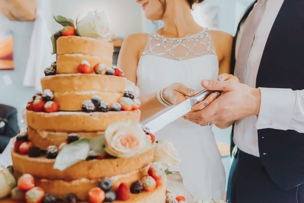 Bride and groom cutting wedding cake