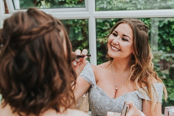 Bridesmaid doing bridal make-up