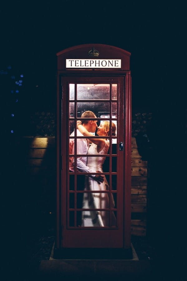 Bride and groom in telephone box