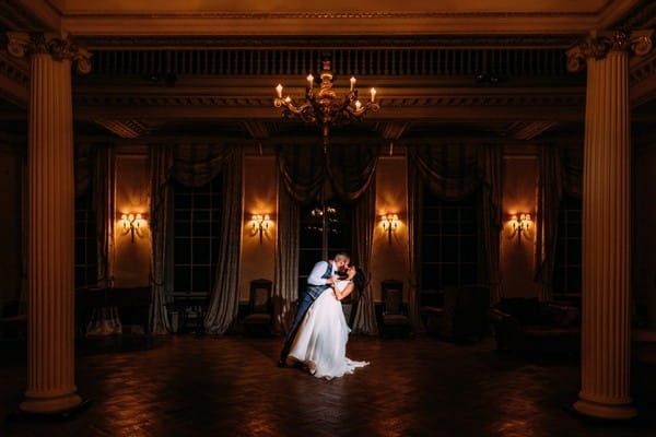 Bride and groom on dance floor in ballroom