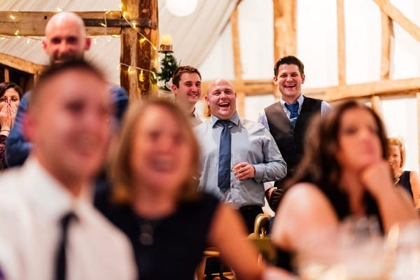 Wedding Guests Laughing at Speech at Winter Wedding