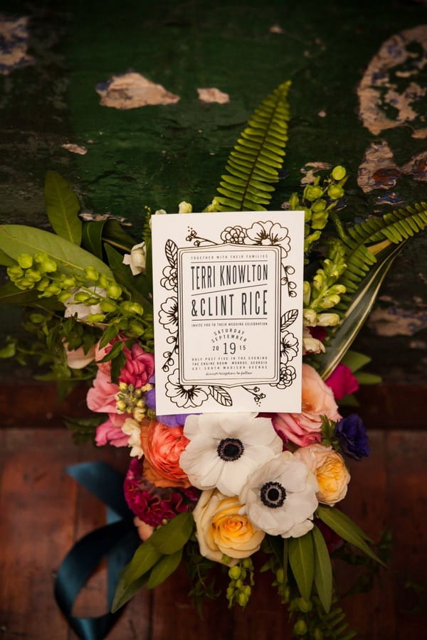 Wedding invitation on colourful flowers