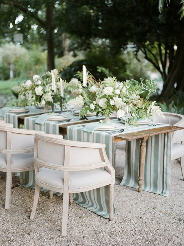 Wedding table with striped runners and floral centrepieces