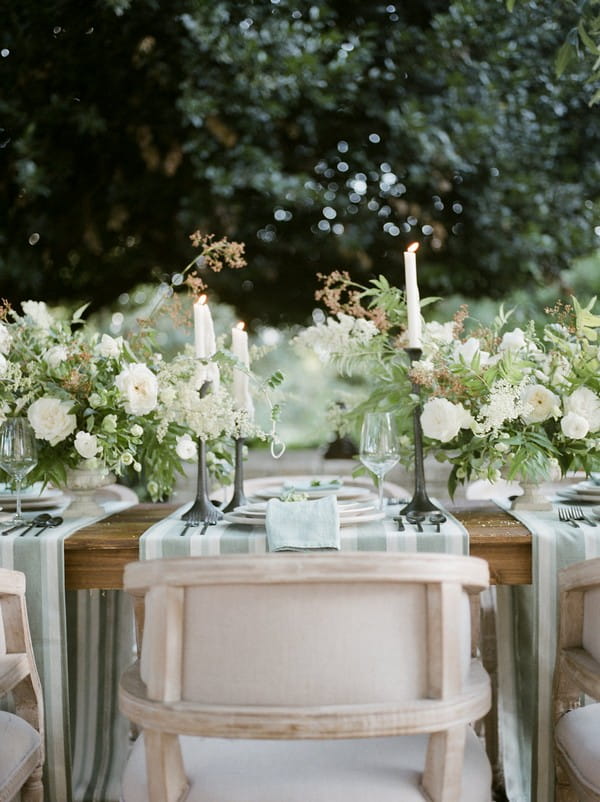 Chair at wedding place setting with flowers and candles