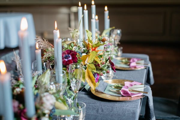 Candles and flowers down centre of wedding table
