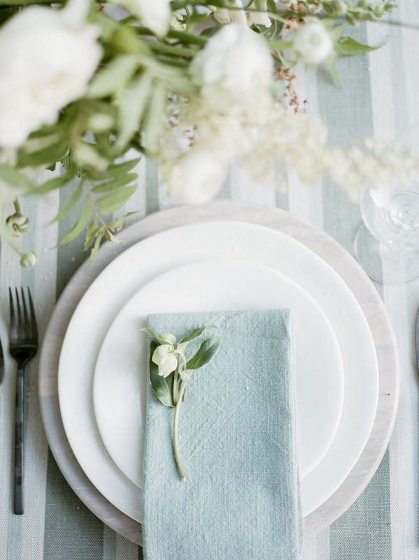 Napkin and flower on plate at wedding place setting