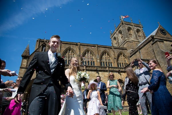 Wedding confetti moment outside Sherborne Abbey