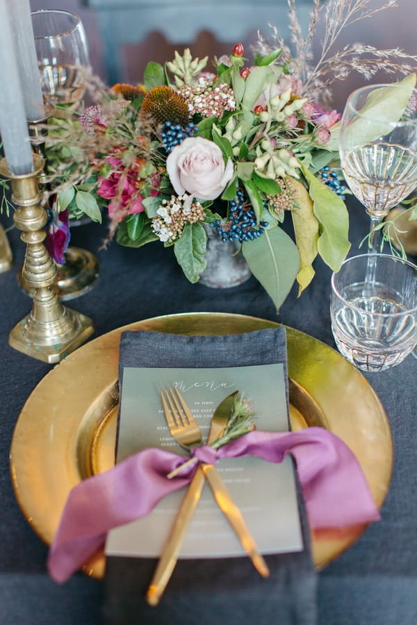 Wedding place setting with gold charger plate and cutlery