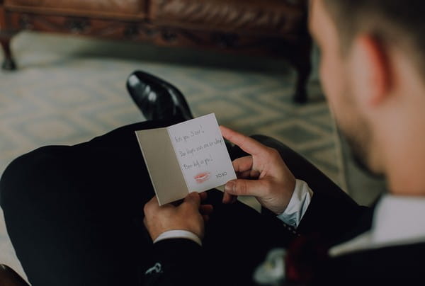 Groom reading card from wife to be