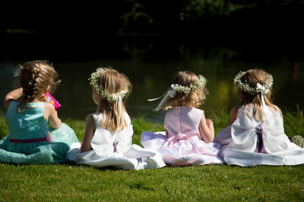 Flower girls sitting on grass