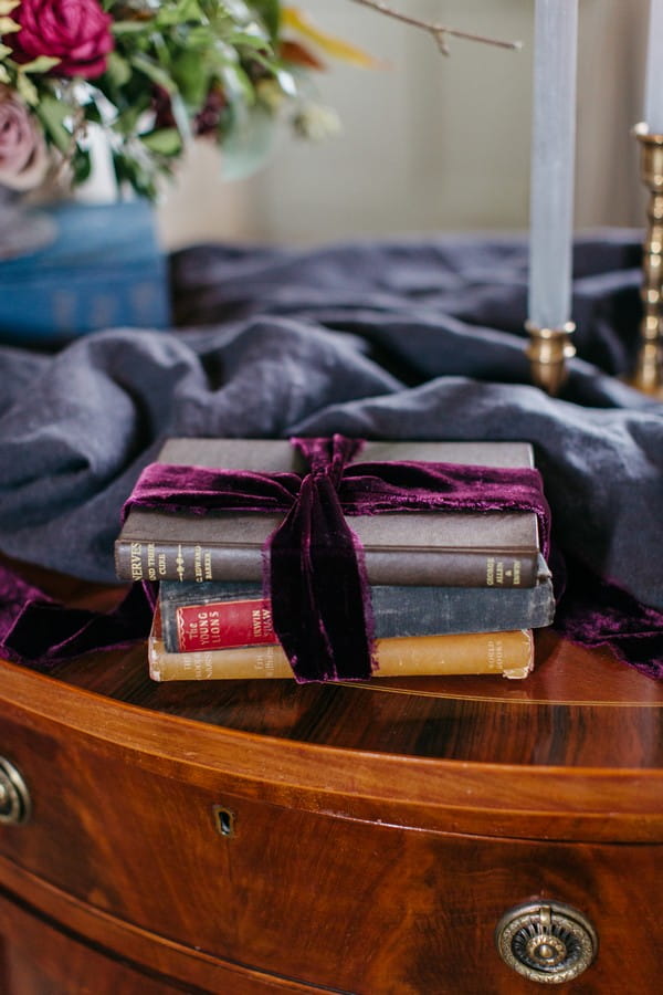 Old books wrapped in purple bow