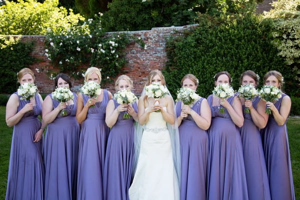 Bride with bridesmaids wearing lavender dresses